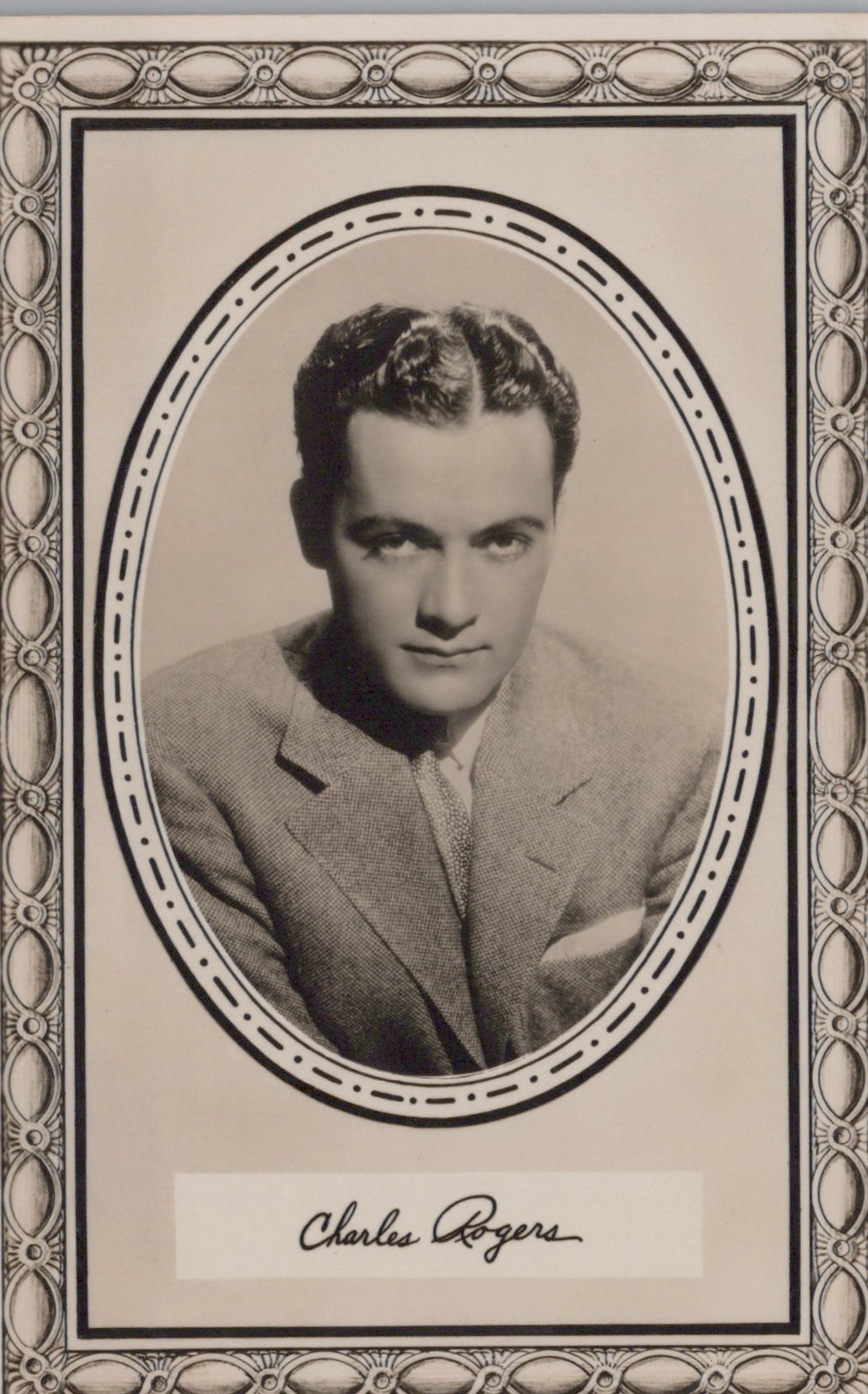 Vintage black and white portrait of a man in a suit with decorative frame and signature at the bottom.