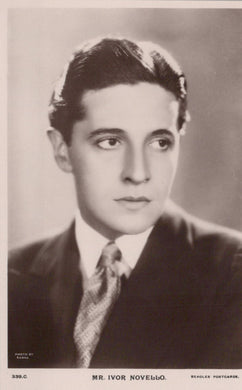 Vintage black and white portrait of a man in formal attire with a plain background