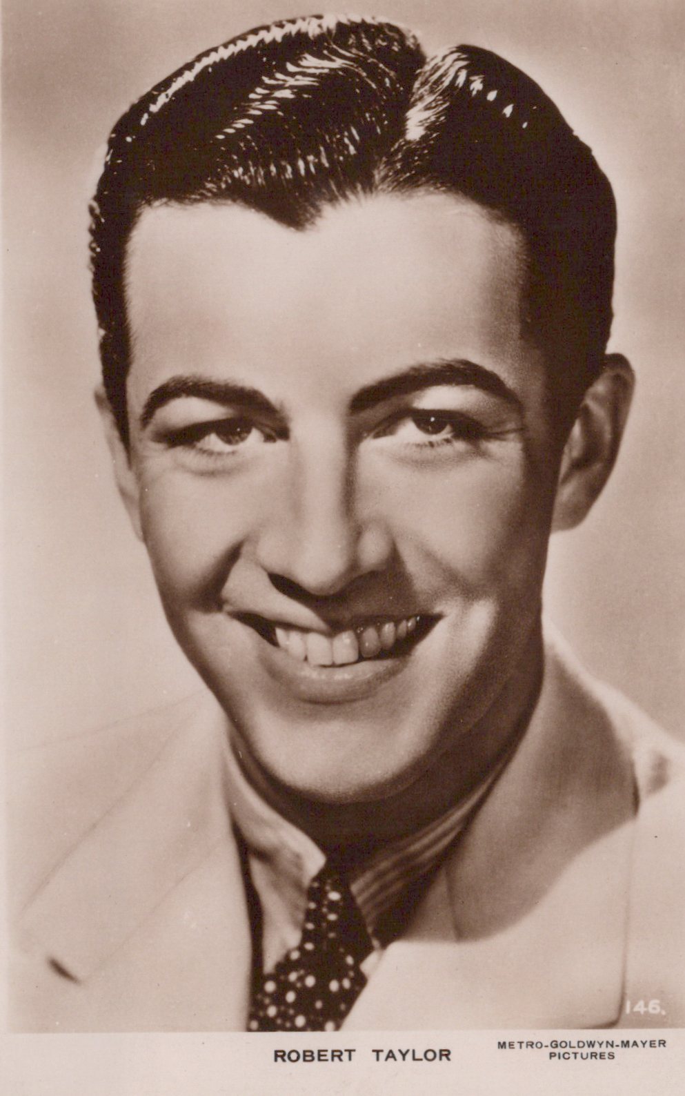 Vintage black and white portrait of a smiling man with a suit and tie, labeled 'Robert Taylor'.