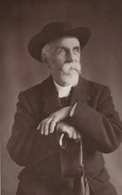 Load image into Gallery viewer, Black and white portrait of a man wearing a hat and coat, holding an umbrella.
