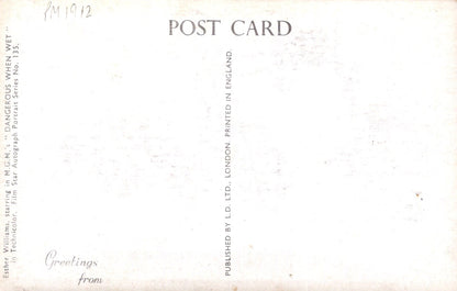 Back of a vintage postcard with text and a light brown background