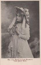 Load image into Gallery viewer, Vintage photograph of a woman in an elaborate dress and hat, holding a flower, with text at the bottom.

