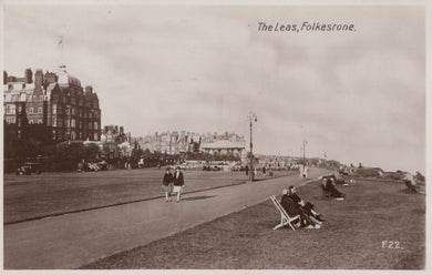 Vintage black and white photo of The Leas in Folkestone with people on the promenade and buildings in the background.