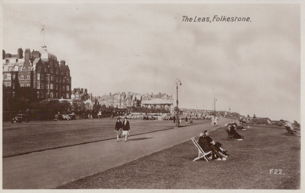 Vintage black and white photo of The Leas in Folkestone with people on the promenade and buildings in the background.