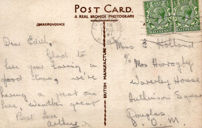 Vintage postcard with handwritten text and postage stamps
