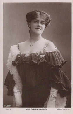 Vintage black and white portrait of a woman in formal attire with decorative elements.
