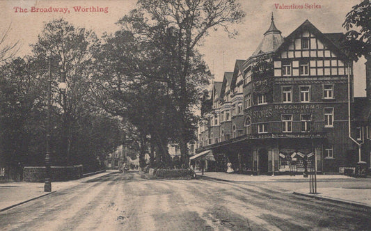 Vintage postcard of The Broadway in Worthing with a building on the right