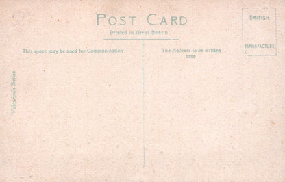 Back of a vintage postcard with printed text and a textured beige background