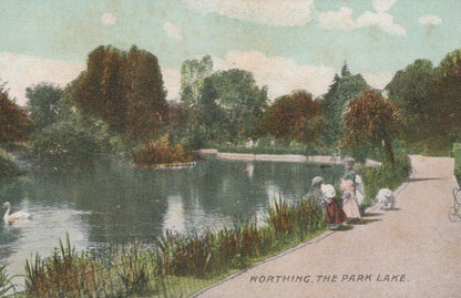 Vintage postcard of a park lake with people and swans, labeled 'Worthing, The Park Lake'.