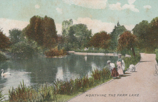 Vintage postcard of a park lake with people and swans, labeled 'Worthing, The Park Lake'.