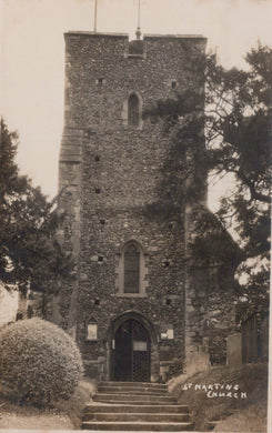 Vintage postcard of a church tower with steps leading up to it, surrounded by trees and shrubs.
