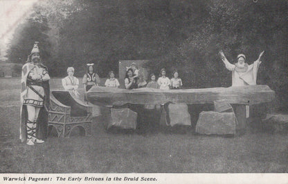 Historical performance scene with people in costumes around a stone circle.
