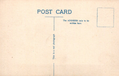 Back of a postcard with text and a rectangular area for writing.