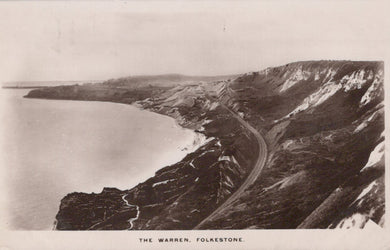Vintage black and white photograph of a coastal landscape with a road and cliffs.
