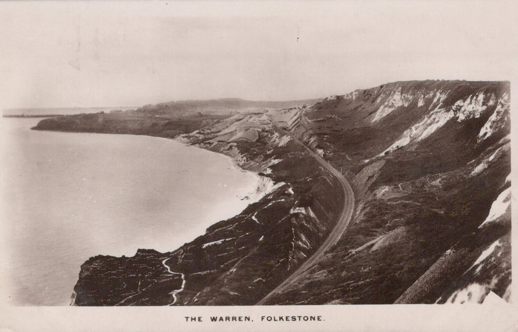 Vintage black and white photograph of a coastal landscape with a road and cliffs.
