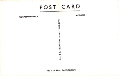 Back of a postcard with text and a signature