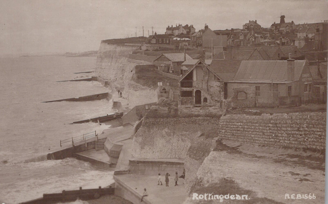 Vintage black and white photograph of coastal buildings and sea.