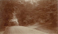 Load image into Gallery viewer, Winding dirt road through a forest with a sepia tone
