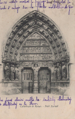 Gothic cathedral portal with intricate carvings and text on a vintage postcard.