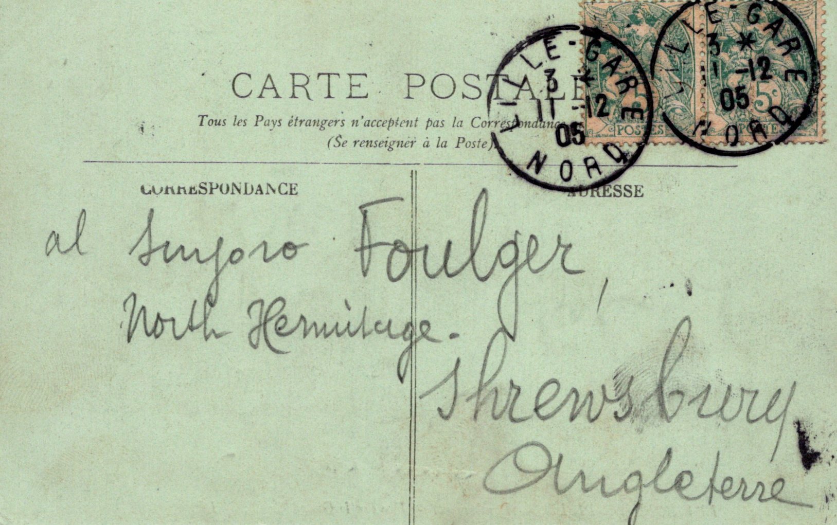 Vintage postcard with stamps and handwritten text on a light green background