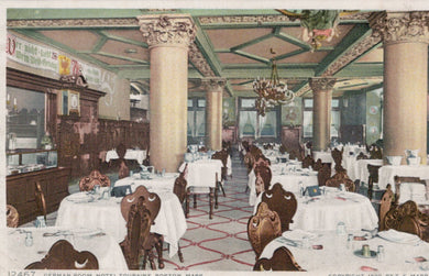 Vintage interior of a restaurant with tables, chairs, and decorative columns.