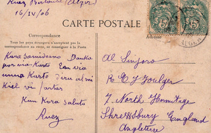 Vintage postcard with handwritten text and postage stamp, featuring a brown background.