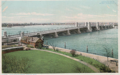 Vintage colorized photograph of a bridge over a body of water with green grass and a path in the foreground.