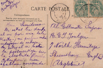Vintage postcard with handwritten text and stamps, addressed to a person in England.