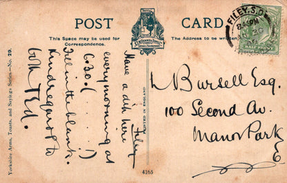 Vintage postcard with text and stamps on a brown background