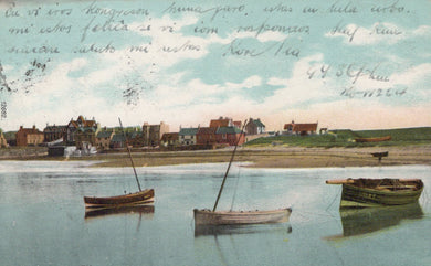 Vintage postcard of a coastal scene with boats and buildings.
