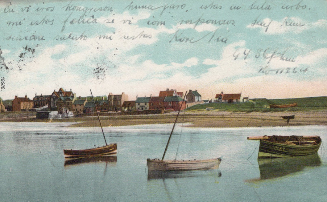Vintage postcard of a coastal scene with boats and buildings.