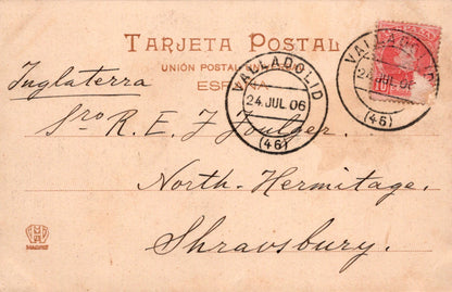 Vintage postcard with stamps and text, featuring a red stamp and black text on a brown background.