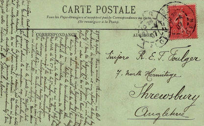 Vintage postcard with text and a red stamp on a green background