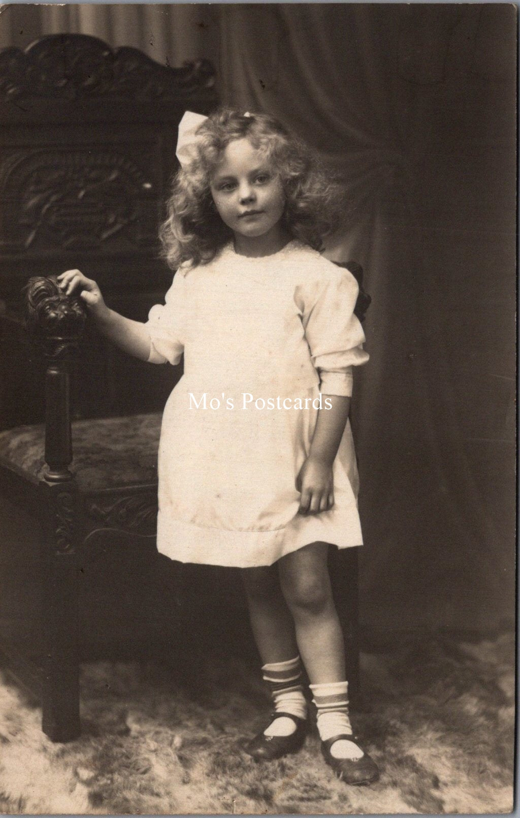 Ancestors Postcard - Young Girl Stood Next to an Ornate Wooden Chair  SW16846