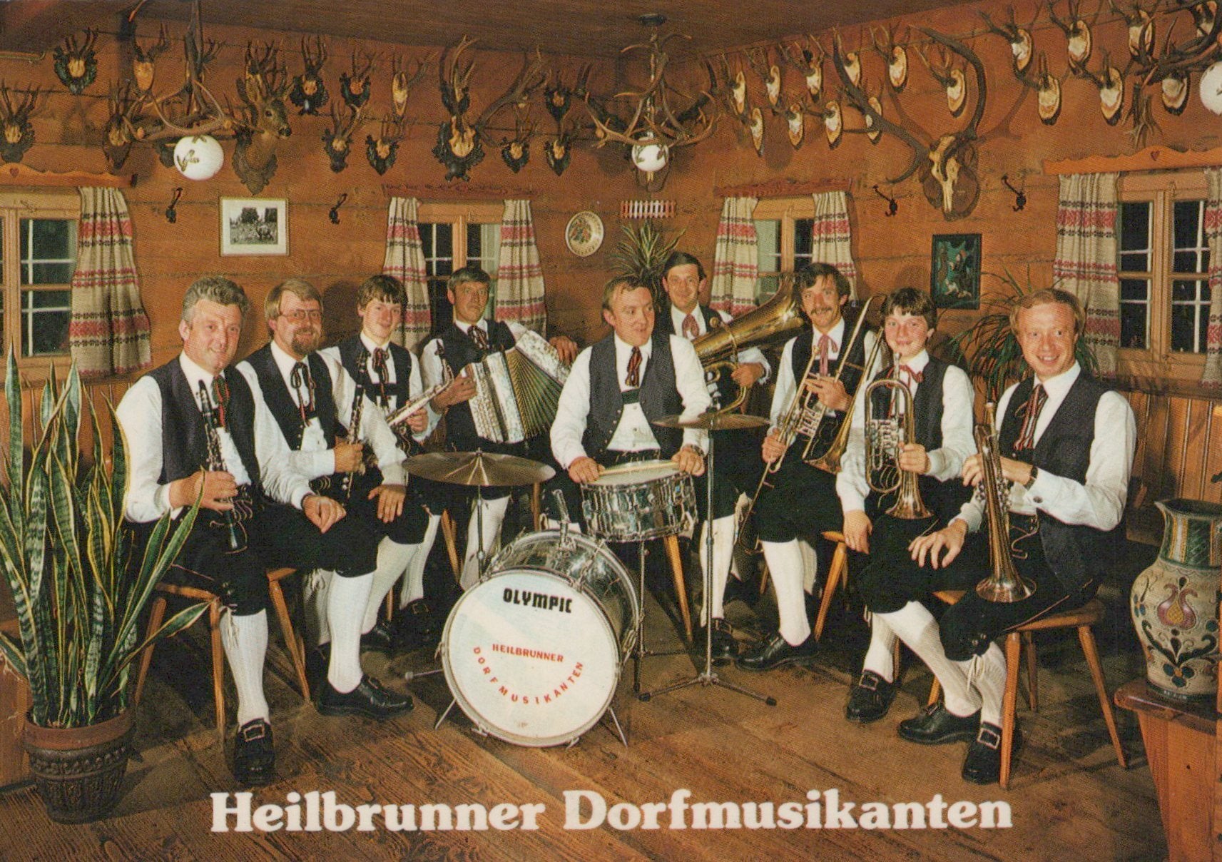 Band playing musical instruments in a room with hunting trophies
