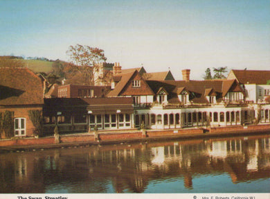 Victorian-style buildings along a waterfront with a clear sky.