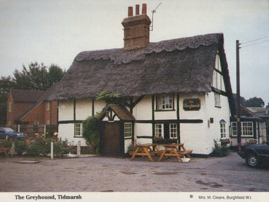 Traditional English pub with thatched roof in Tidmarsh, featuring a sign for 'The Greyhound'.