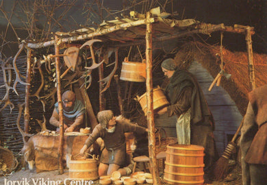 Viking-themed scene with people around a wooden structure, likely a market or trading area.