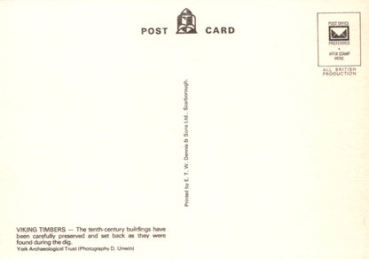 Back of a postcard with text and a logo on a beige background