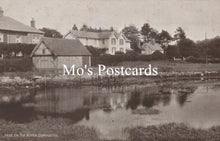 Load image into Gallery viewer, Vintage black and white photo of a village scene with houses and a pond, featuring &#39;Mo&#39;s Postcards&#39; text.

