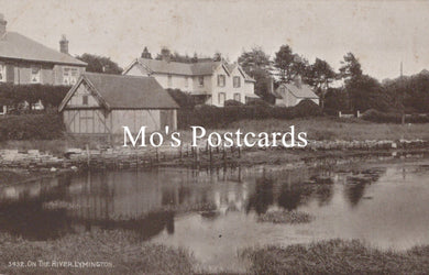 Vintage black and white photo of a village scene with houses and a pond, featuring 'Mo's Postcards' text.