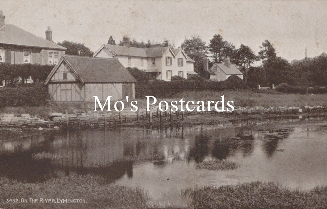 Vintage black and white photo of a village scene with houses and a pond, featuring 'Mo's Postcards' text.