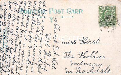 Vintage postcard with text and a stamp on a light brown background