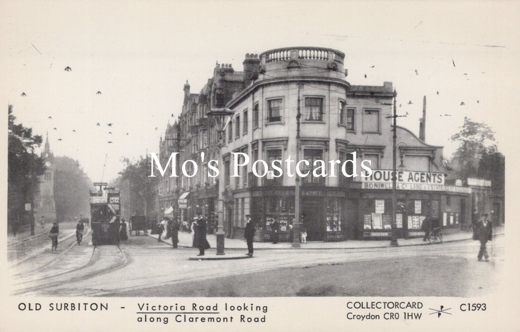 Vintage black and white postcard of a street scene with buildings and people on a street corner.