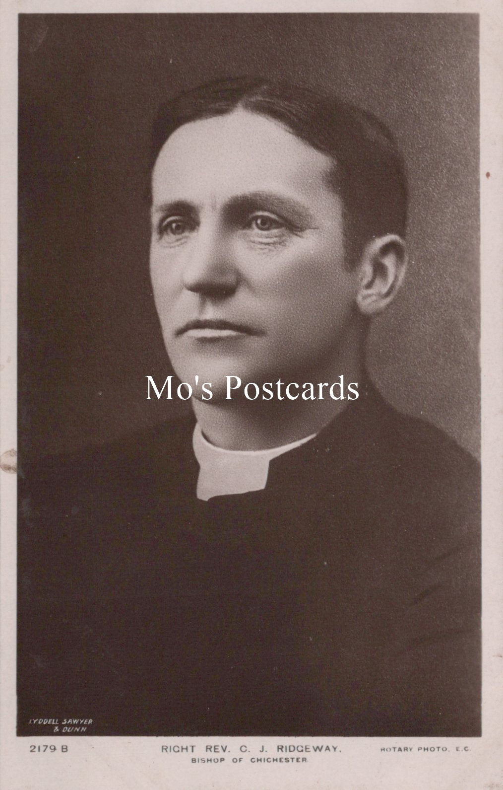 Black and white portrait of a man in clerical collar with 'Mo's Postcards' text overlay.
