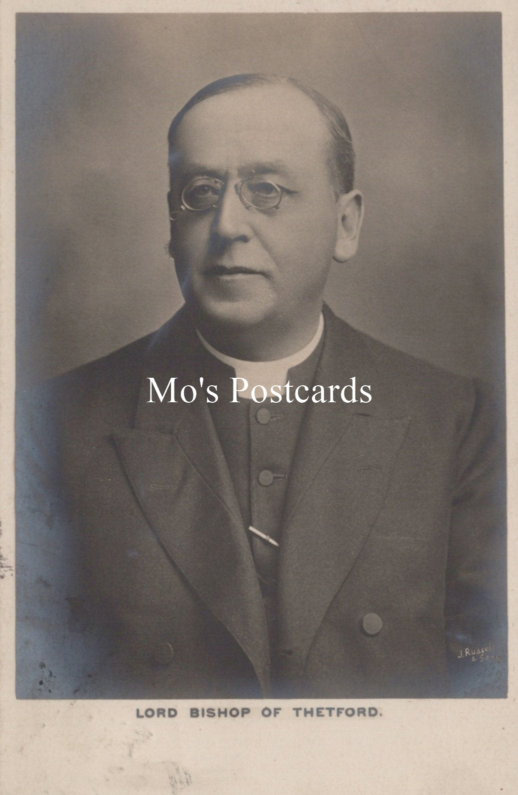 Vintage black and white portrait of a man in formal attire with 'Mo's Postcards' text overlay.