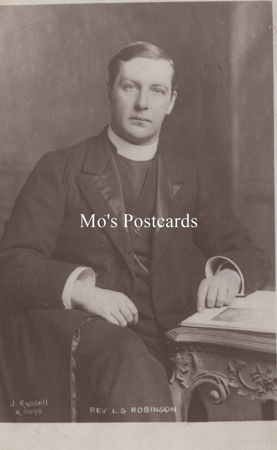 Vintage black and white photograph of a man in formal attire with 'Mo's Postcards' text overlay.