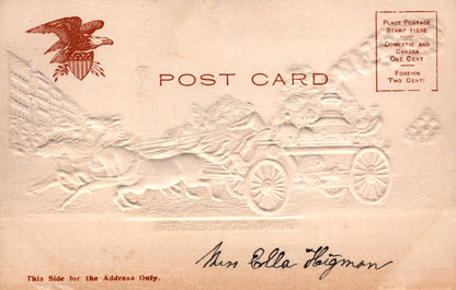 Vintage postcard with embossed design of an eagle and a carriage, featuring the text 'POST CARD'.