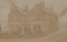 Load image into Gallery viewer, Vintage sepia-toned photograph of a large house with a prominent chimney.
