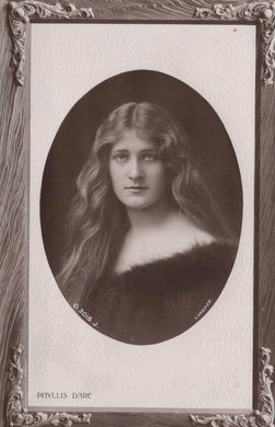 Vintage black and white portrait of a woman with long hair, framed in ornate style.